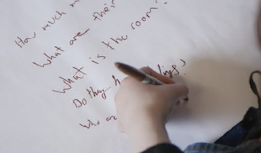 A student drafting a need to knows list for a project