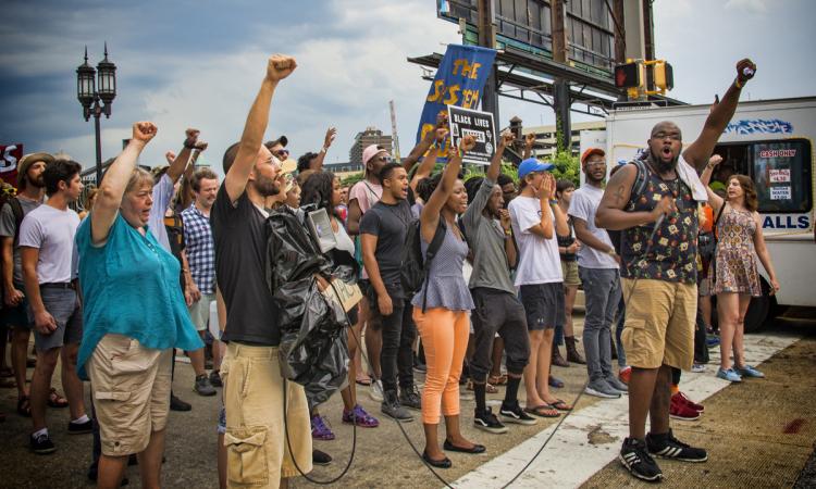 Group of demonstrators with fists raised in the air